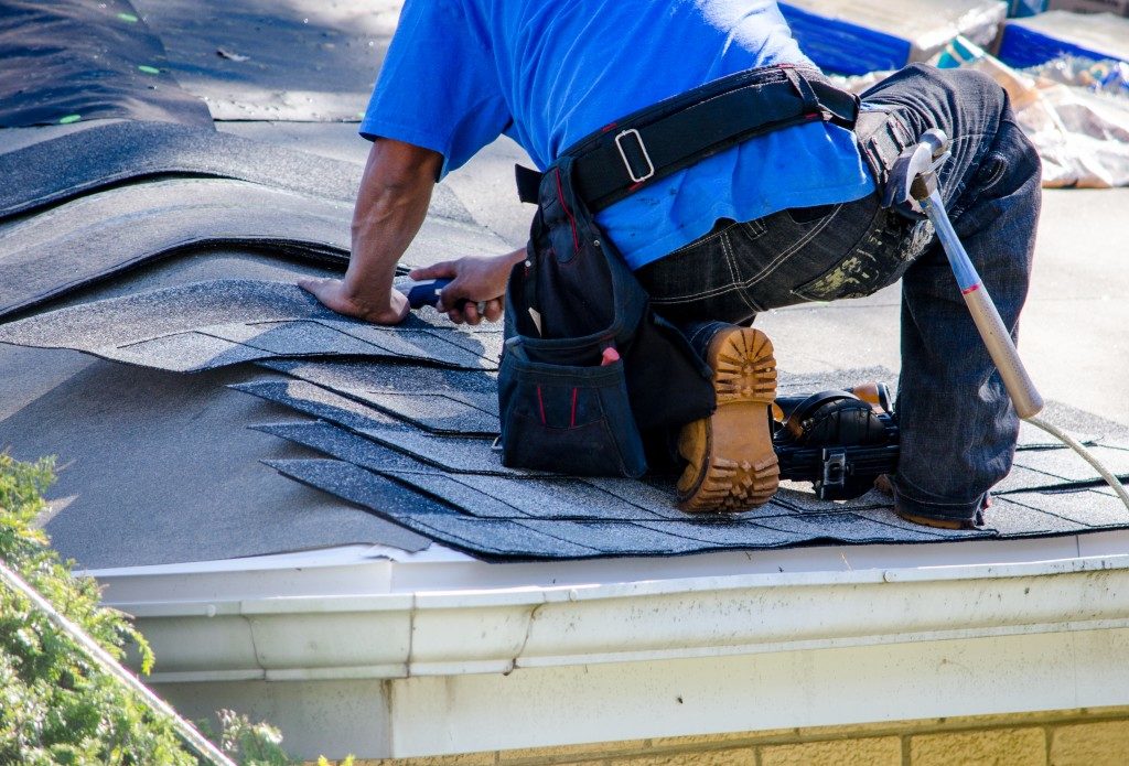 Man fixing a flat roof