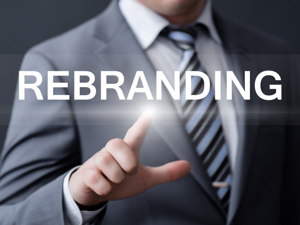 business, technology, internet and networking concept - businessman pressing rebranding button on virtual screens