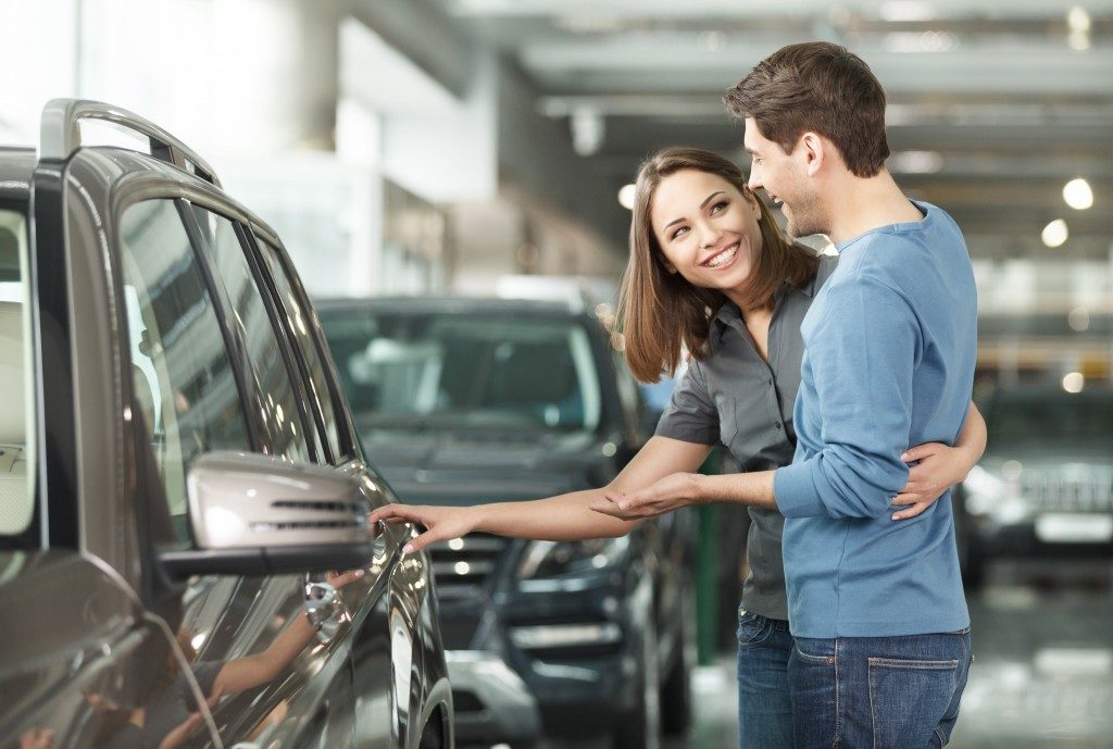 Couple looking at new car