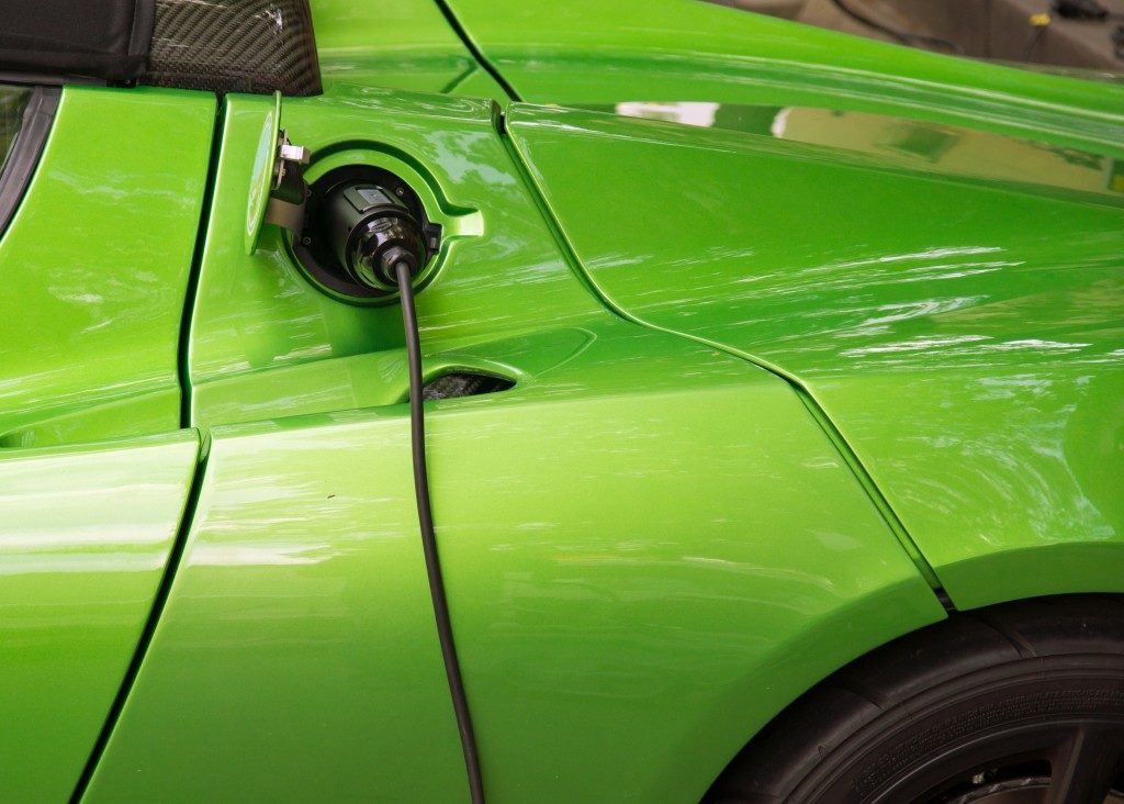 lime green electric car being charged