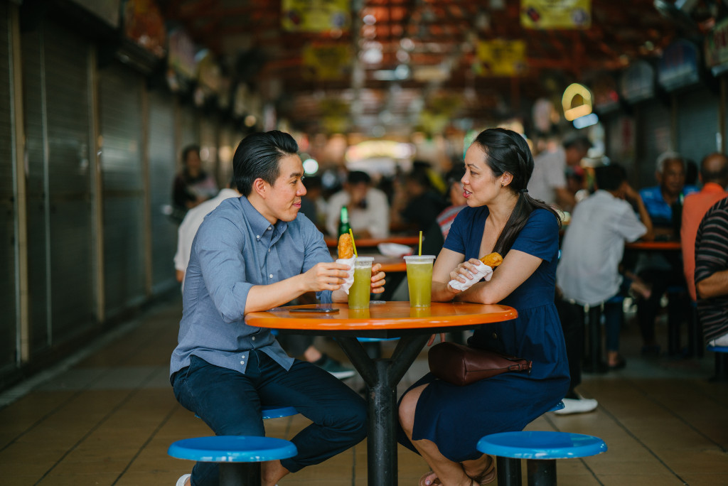 man and woman eating street food